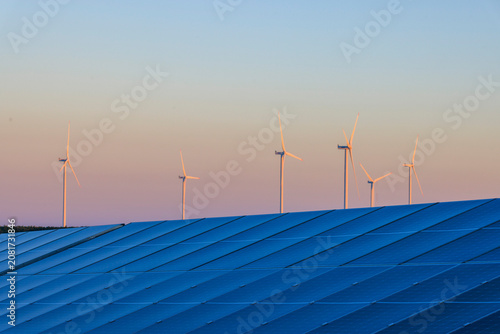 Solar Power Plant with Wind Turbine at Dusk
