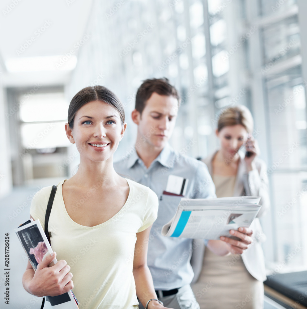 Obraz premium Happy, woman and wait in airport with travel holiday, magazine or queue for boarding overseas flight. Person, smile and people line up in terminal for international vacation, trip and departure.