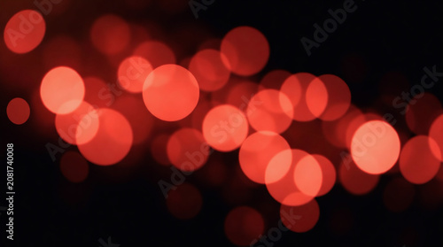 Soft pink glowing bokeh light circles and delicate sparkle particles floating dreamily against a pure solid black background.