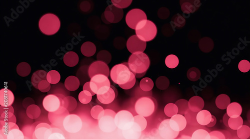 Soft pink glowing bokeh light circles and delicate sparkle particles floating dreamily against a pure solid black background.
