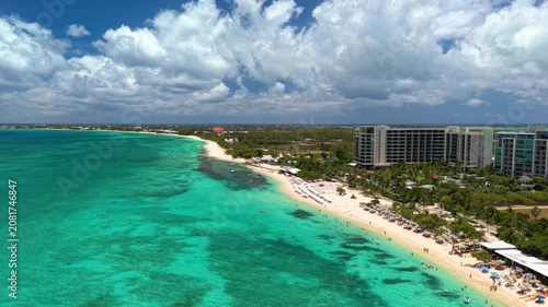 Seven Mile Beach, Cayman Islands: Aerial drone view of Grand Cayman Island with turquoise water, white sandy shoreline, luxury resorts, and tropical coastline - landscape panorama of Caribbean Sea
