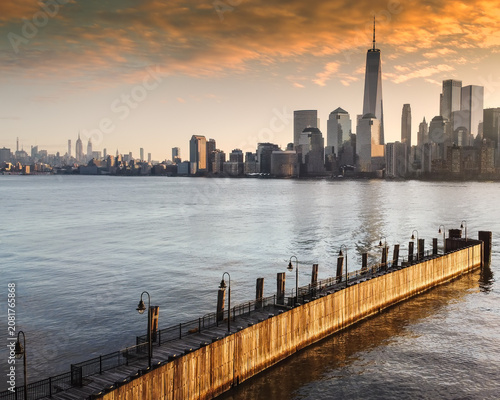 Aerial of the New York City skyline from New Jersey with a long dock in foreground in morning light