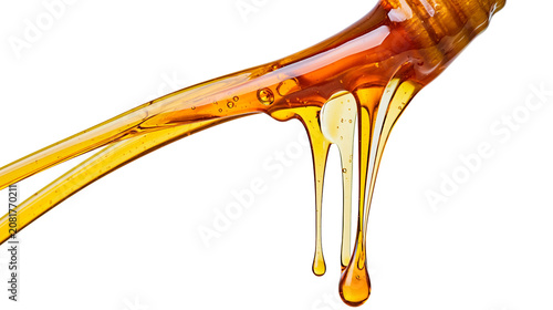 Photos Golden honey dripping from wooden dipper, isolated on transparent background