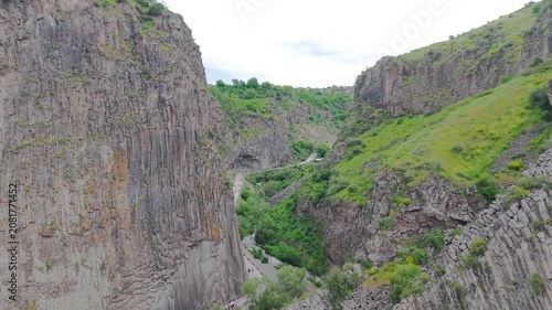 Symphony of the Stones in Garni Gorge, Armenia. Spectacular natural basalt rock columns with hexagonal volcanic formations along the Azat River beneath the ancient Garni Temple. Stunning geological la