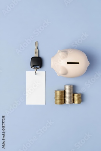 Piggy bank with car key and coin stacks as a visual concept for automotive financing, banking services, personal savings, and loan advertising.