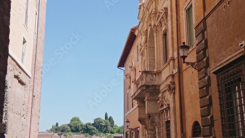 Historic Roman Street Framed by Stone Archway in Rome, Italy