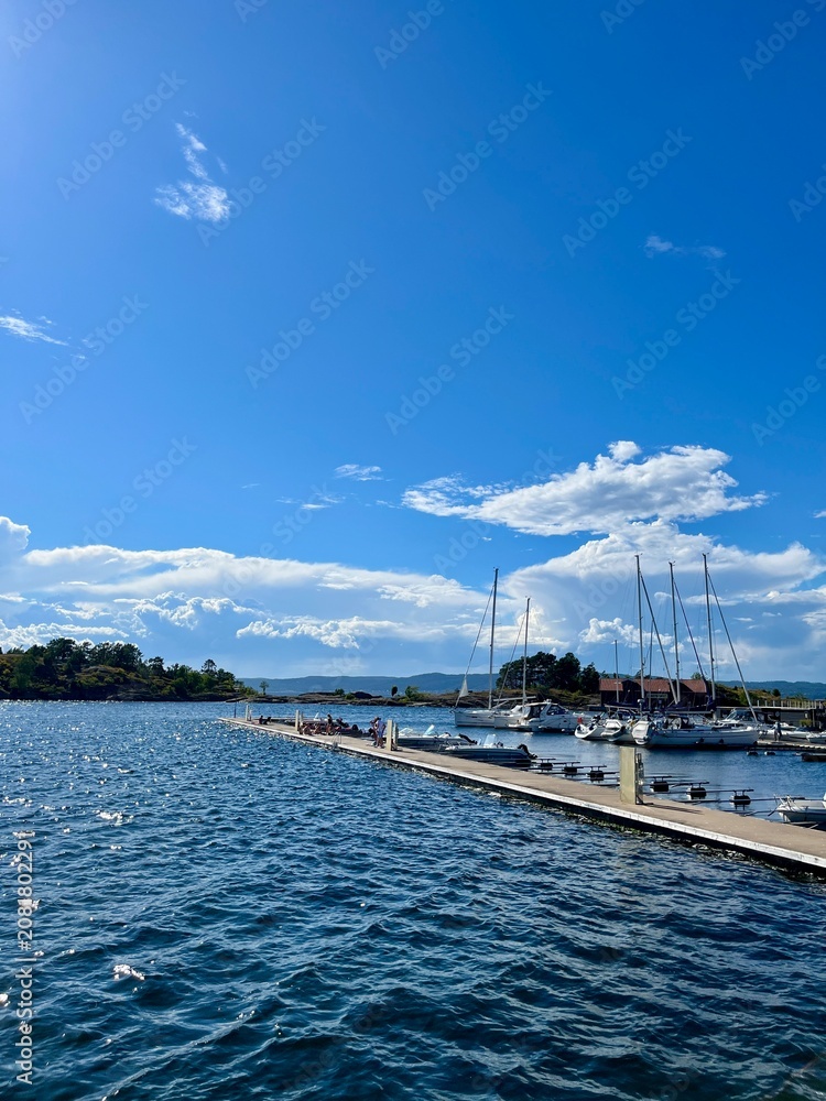 Fototapeta premium Marina with sailboats moored along a wooden pier in Son, Norway