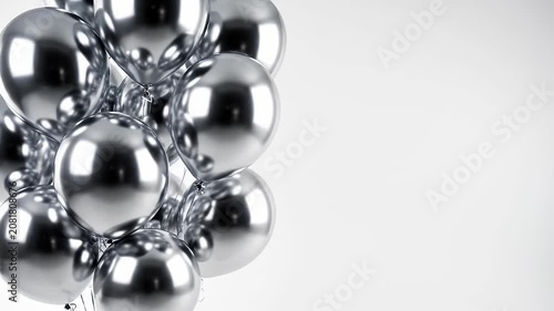 Shiny silver metallic balloons against white background.
