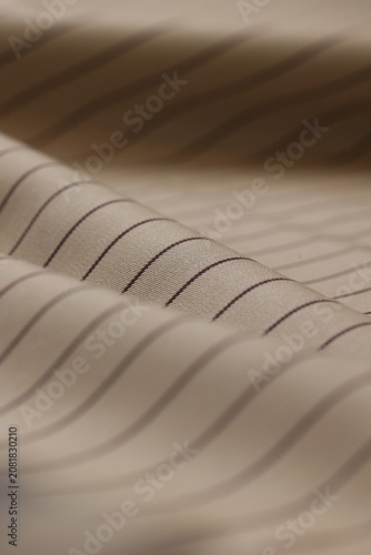 Beige pinstripe luxury wool & viscose suit fabric for bespoke tailoring in studio.