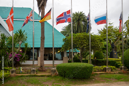 Phi Phi Islands, Thailand – May 18, 2026: National flags from several countries fly outside a waterfront hotel and resort on Phi Phi Don Island.