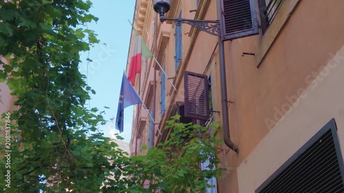 Historic Rome Street with Italian and European Union Flags