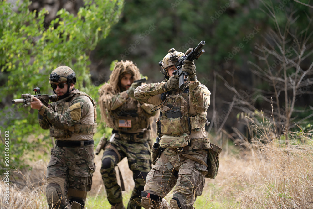 Fototapeta premium Team of military soldier army force having engage and rescue mission in dangerous battlefield for actual field operation, peace and conflict resolution