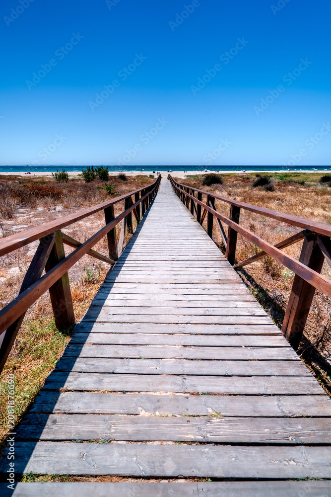 Fototapeta premium Vertical photo wooden entrance to Los Lances Beach in Tarifa, Costa de la Luz, Spain.