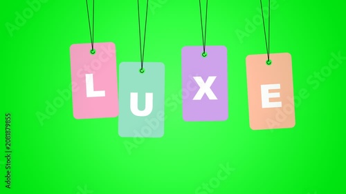 Luxe Word on Colorful Tags Swinging on Green Screen Background.