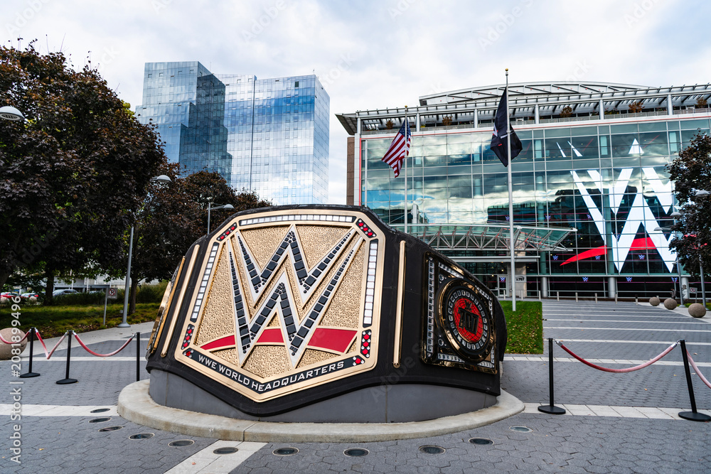 Fototapeta premium Miami, Florida, USA - October 22, 2025: WWE Universal Championship belt sculpture. WWE logo. Main headquarters in US. WWE World Wrestling Entertainment