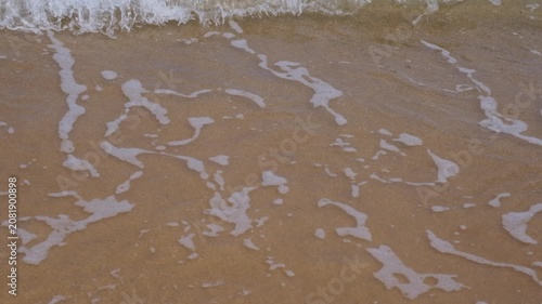 Sea waves rolling onto a sandy beach, the concept of rest and relaxation