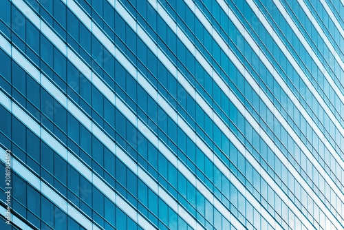 Abstract view of a modern blue glass skyscraper facade. Concept of corporate business, futuristic architecture, and urban background.
