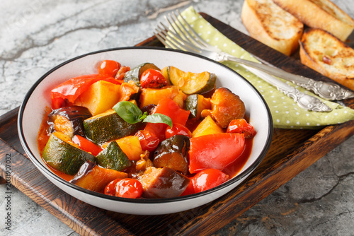 Canvastavla Ciambotta Italian ratatouille rustic Southern Italian vegetable stew brings together eggplant, zucchini, bell peppers, cherry tomatoes closeup on the plate on the table
