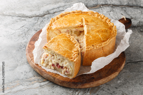 Cuadro en lienzo Pizza Chena or Pizza Rustica is a traditional southern Italian savory pie filled with a generous mixture of cheeses, cured meats, and eggs closeup on the wooden board