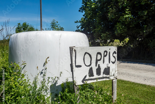 Photography Sandvik, Sweden A hay bale and a sign in Swedish for a rummage sale, Loppis