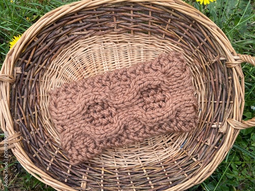 a basket of knitting, hand knit headbands with cable stitch pattern 