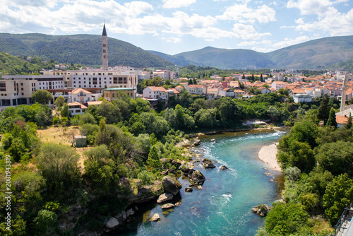 Bild auf Leinwand High-angle panoramic view of the turquoise Neretva River flowing through the gre