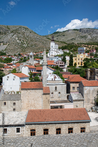 Принти на полотні historic town of Mostar in Bosnia and Herzegovina, featuring the Karadoz Bey Mosque and the Franciscan Church tower, captured from the minaret of the Koski Mehmed Pasha Mosque