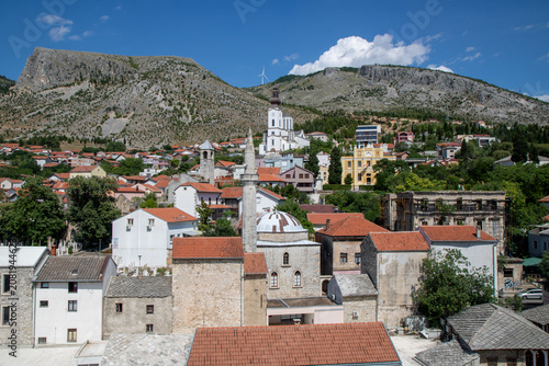 Obraz na płótnie historic town of Mostar in Bosnia and Herzegovina, featuring the Karadoz Bey Mosque and the Franciscan Church tower, captured from the minaret of the Koski Mehmed Pasha Mosque