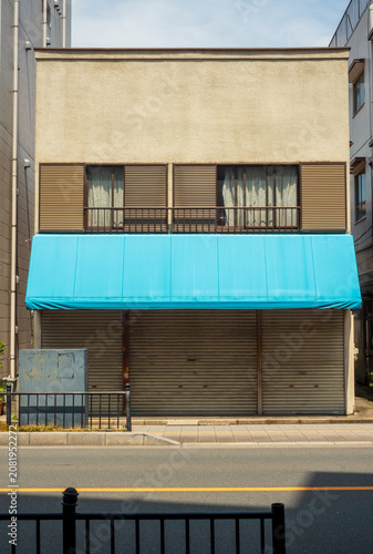 Vintage Building Facade with Bright Blue Awning
