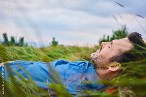 Relaxed man lying in grass
