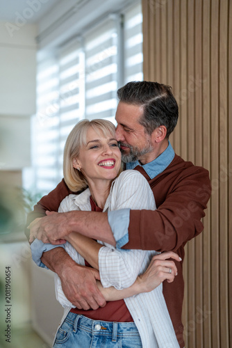 Happy couple embracing enjoying loving moment at home