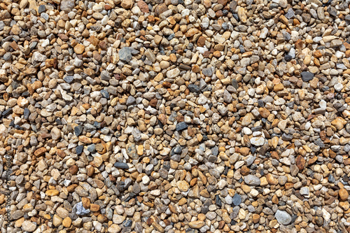 Homogeneous scattering of small pebbles and stones, natural stone texture