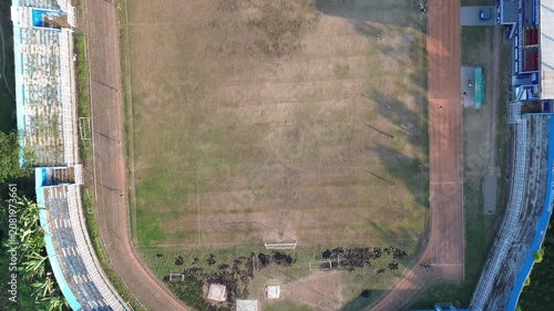 Aerial View of Empty Stadium Field with Running Track and Dry Grass Texture