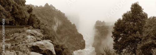 Misty Mountain Landscape with Trees and Rocky Outcrops.