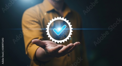 Person holding a glowing digital checkmark icon for quality assurance and business certification in a professional dark setting