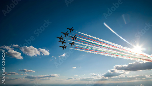 Six jets flying in formation with colored smoke trails