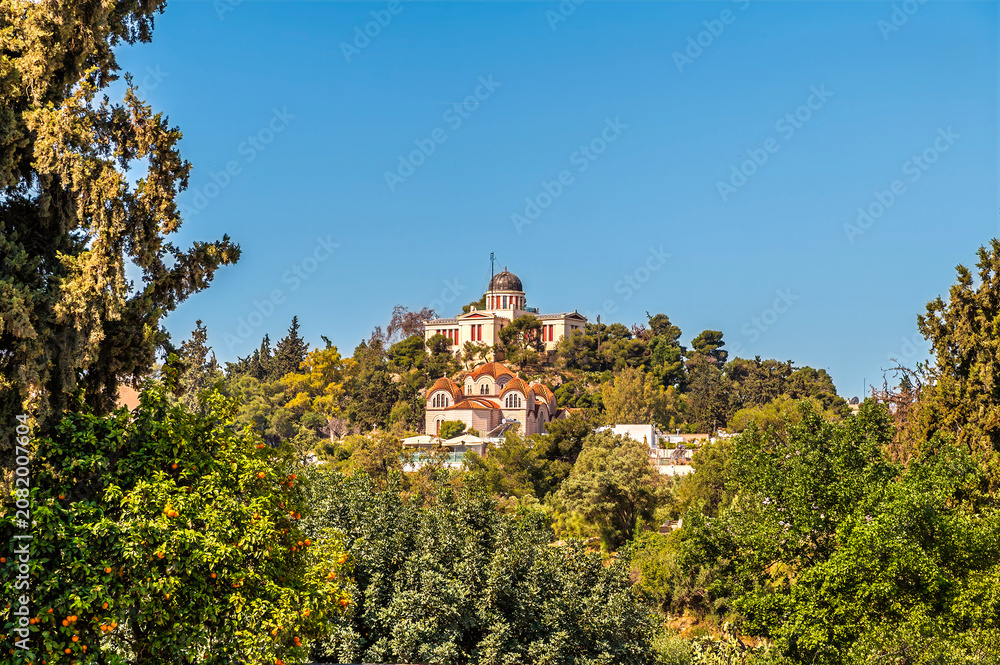 Obraz premium A view towards the Hill of the Nymphs in Athens, Greece in early summertime