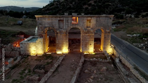 Aerial Drone View of the Illuminated Roman Triumphal Arch at Patara Ancient City, Antalya, Türkiye