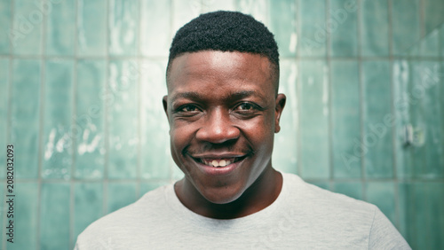 Smiling Young Man Portrait With Clean Fresh Look and Tiled Bathroom Background