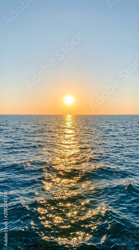 Golden sunset over the calm ocean horizon
