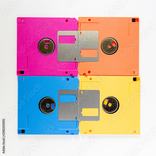 Canvastavla Four Colorful Floppy Disks in Grid Arrangement on White Background