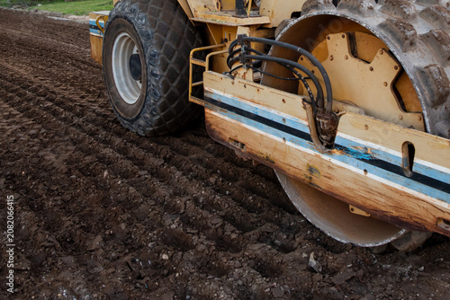 Photography Side View of Padfoot Soil Compactor Roller Machine Hardening Dirt Road Subgrade