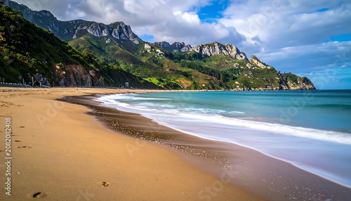 A serene beach with gentle waves and a mountainous backdrop
