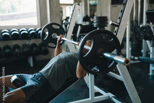 Obraz na plátně Barbell bench gym man weight exercise strength fitness muscle workout, man lifti