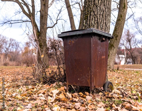 Rusty bin in autumn park