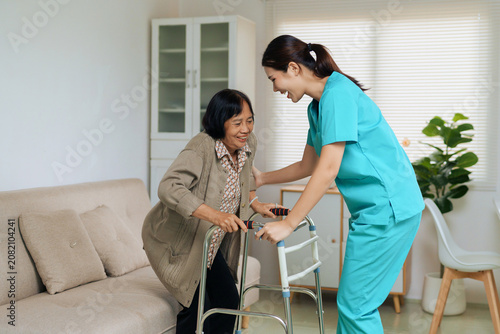 Caregiver assisting senior woman with walker