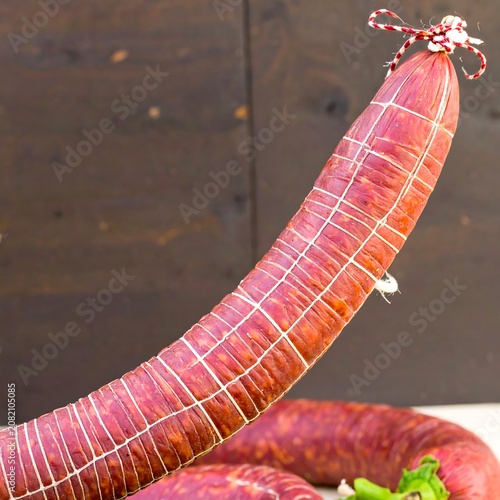 Long cured sausage tied