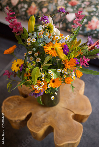 Bright mixed flower bouquet with orange calendula, white chamomile, yellow lily buds. High quality photo