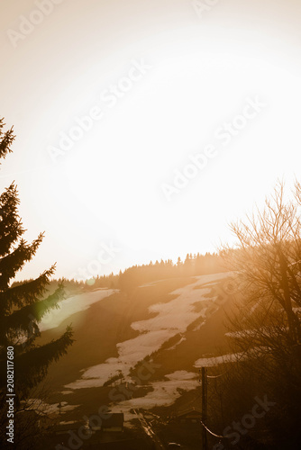 Tablou pe pânză Sunset over mountains with lingering snow in spring
