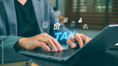 Online tax payment concept, accounting and finance with digital icons above laptop